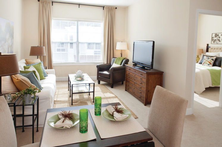 Furnished living room space with sofa, table, and seating area.