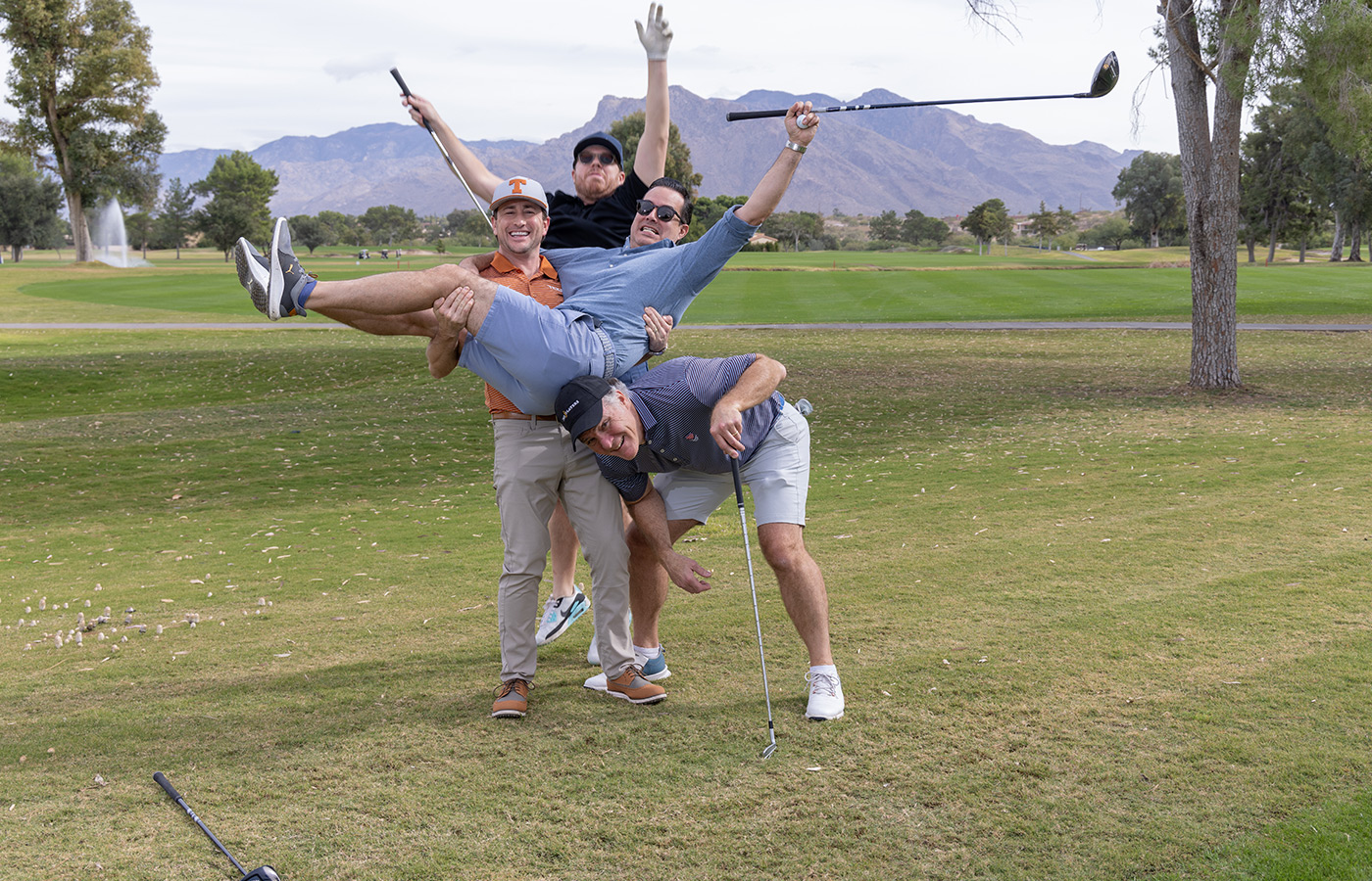 A group of people standing next to each other on the golf course.