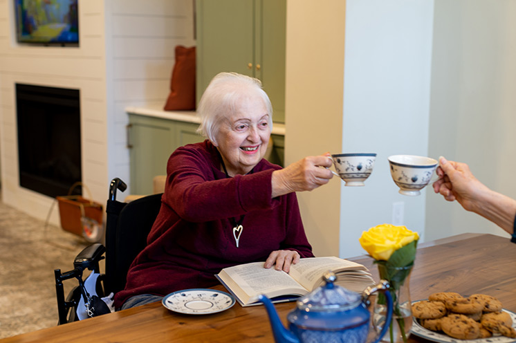 People toasting with tea cups.