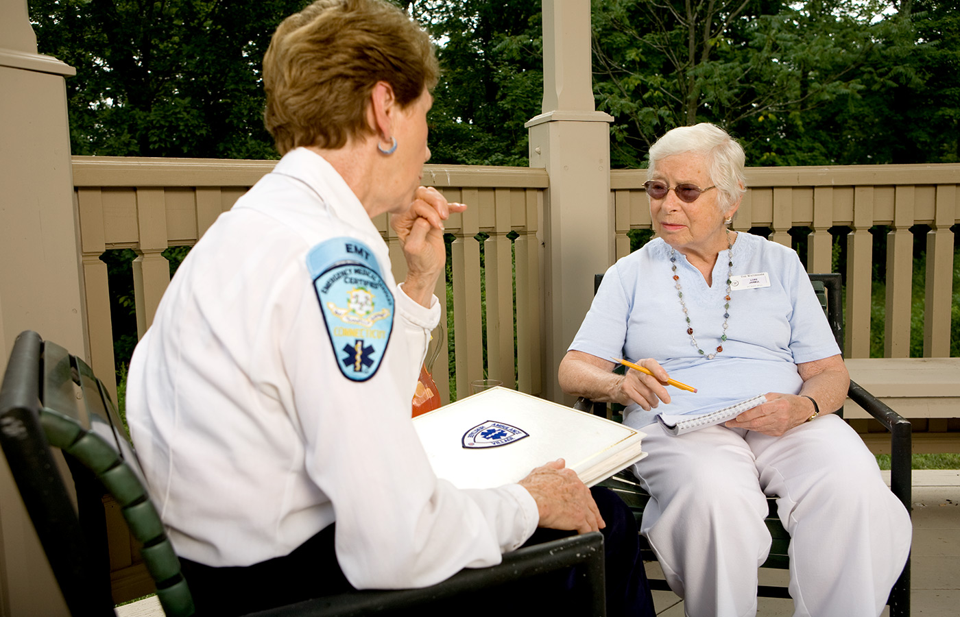 A medical professional talking with a resident.