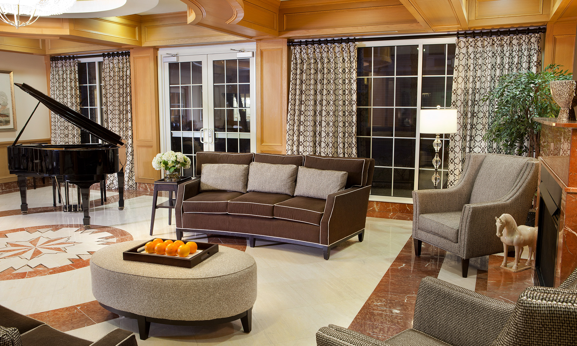 Seating area with piano and sofas.