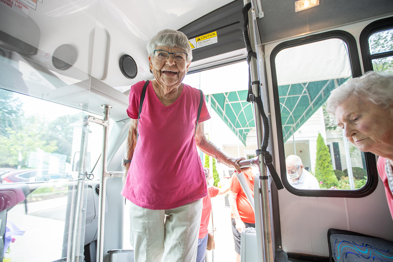 A resident is entering a bus.