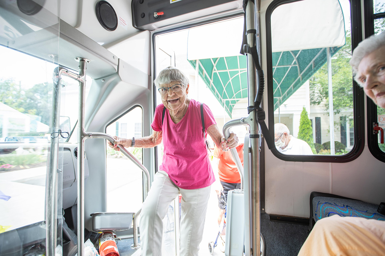 A resident is entering a bus.