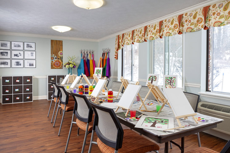 A table with canvases and paint materials.