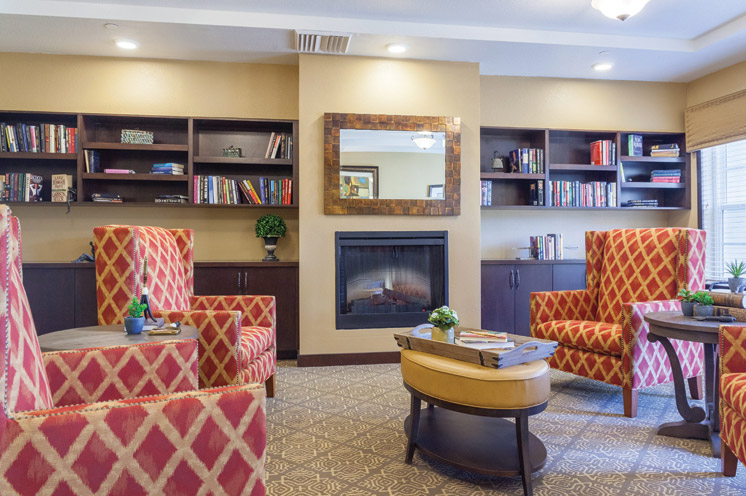 A common area with elegant seating and a fire place.