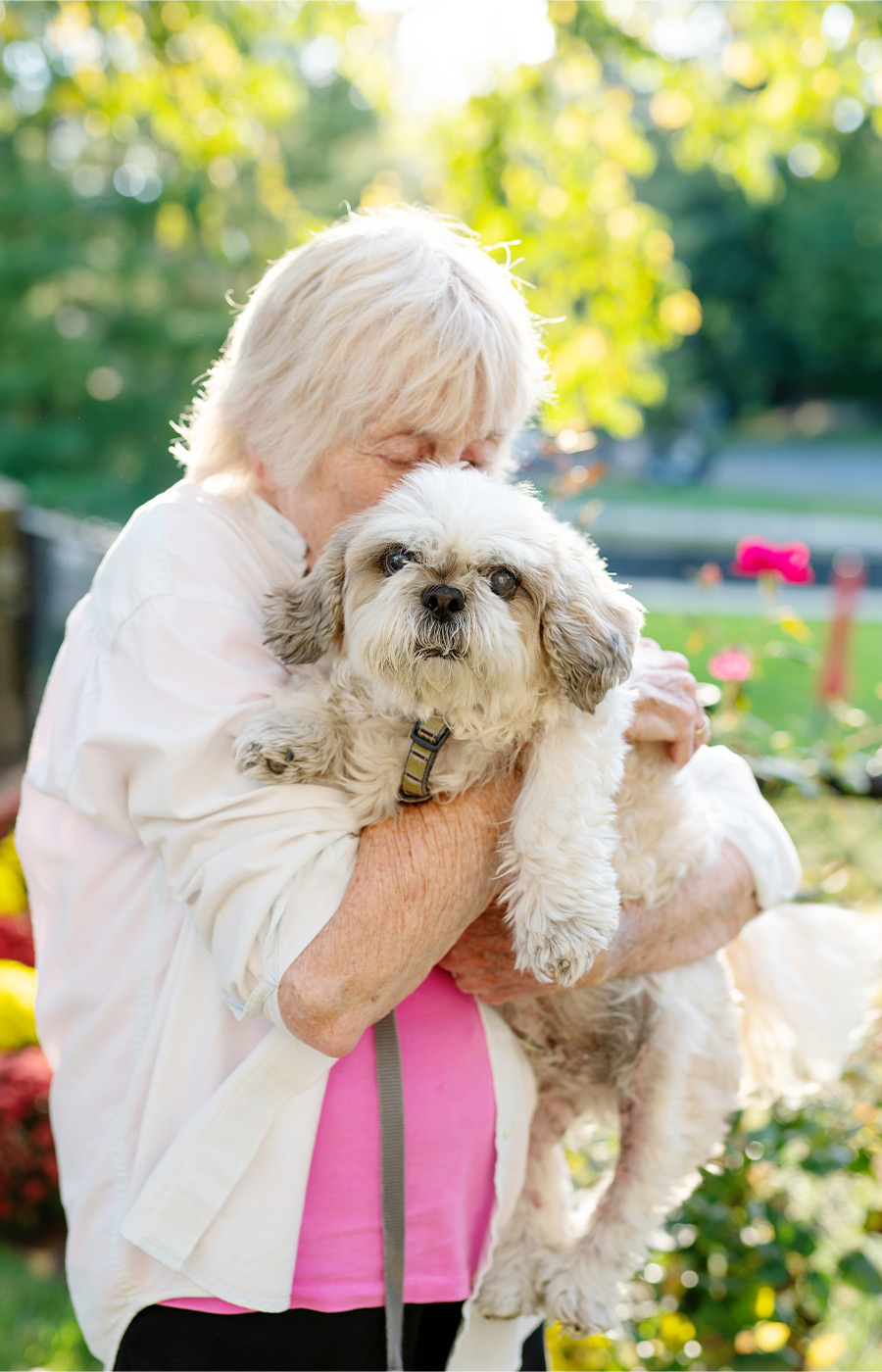 A person hugging their dog.