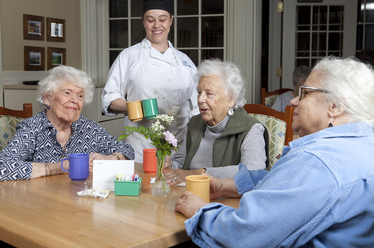 Three residents sitting in a dining area.