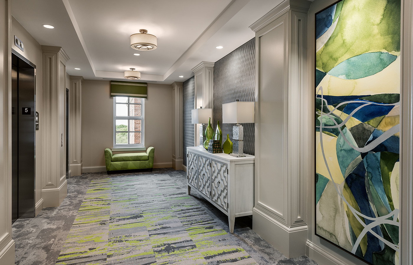 view of decorated hallway with an elevator to the left 