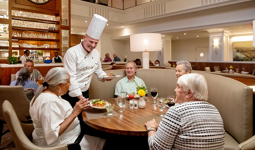 Chef Kertes serving dinner to residents.