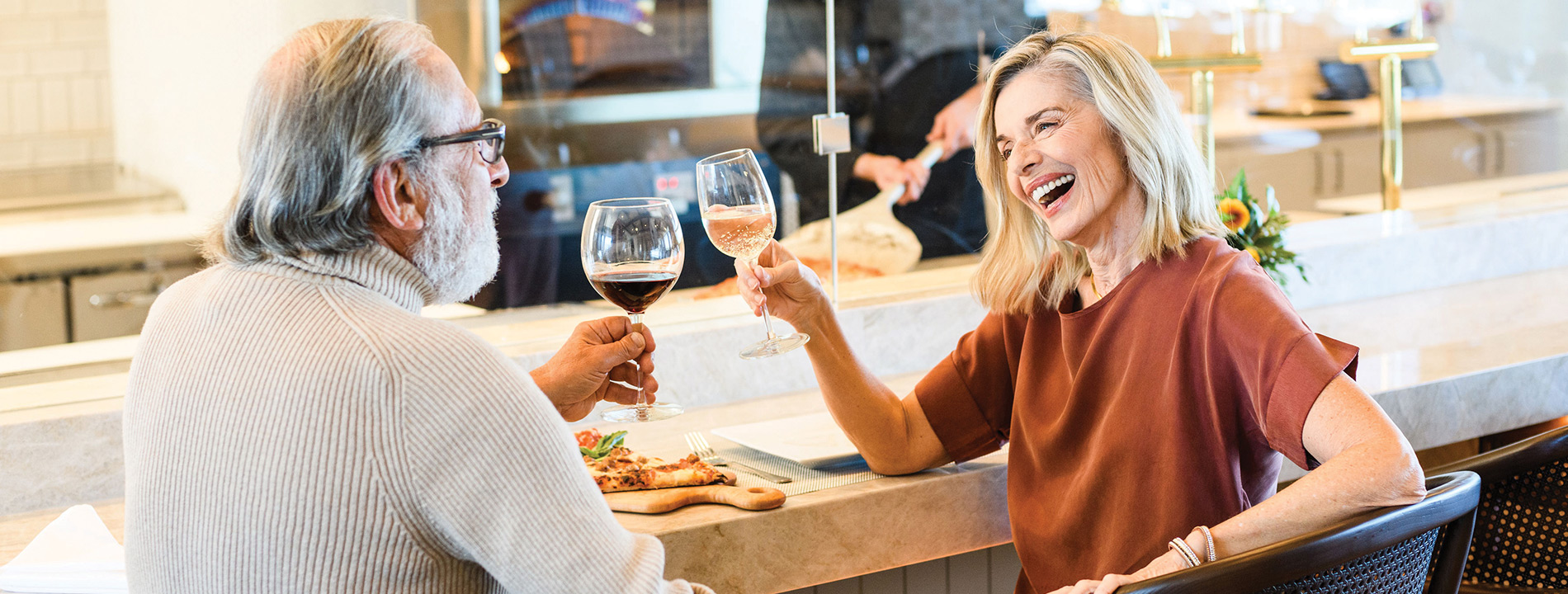 Couple toast with a glass of wine.