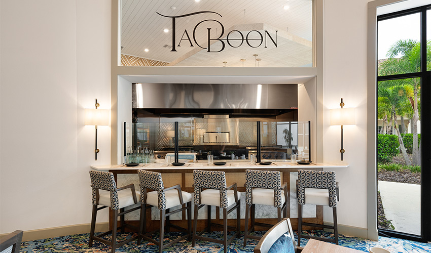 A counter with seating facing the kitchen.