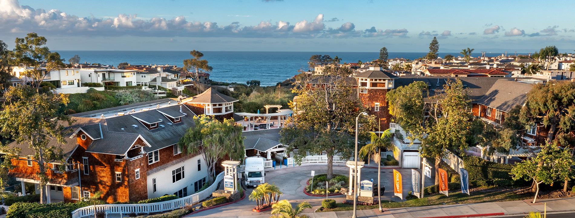 Aerial exterior of Crown Cove with the ocean in the background.