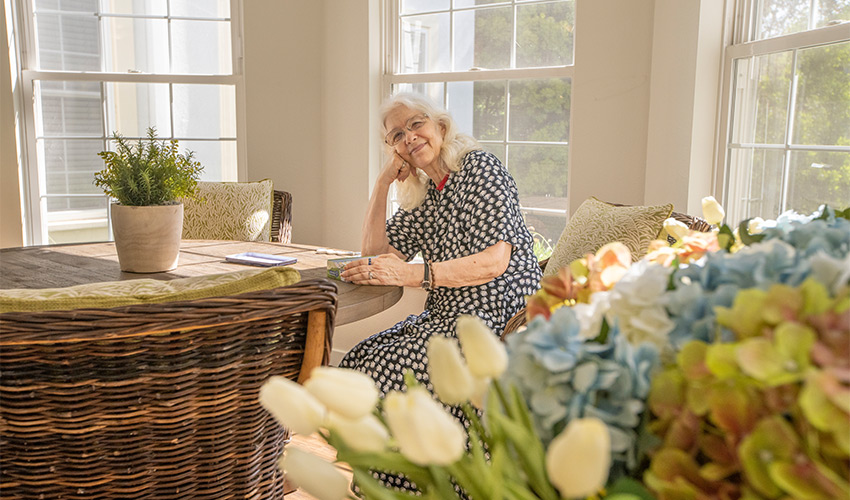 A person sitting in a sun room.