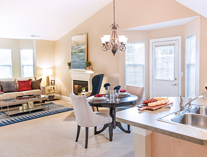 Furnished living room space with sofa, table, and seating area.