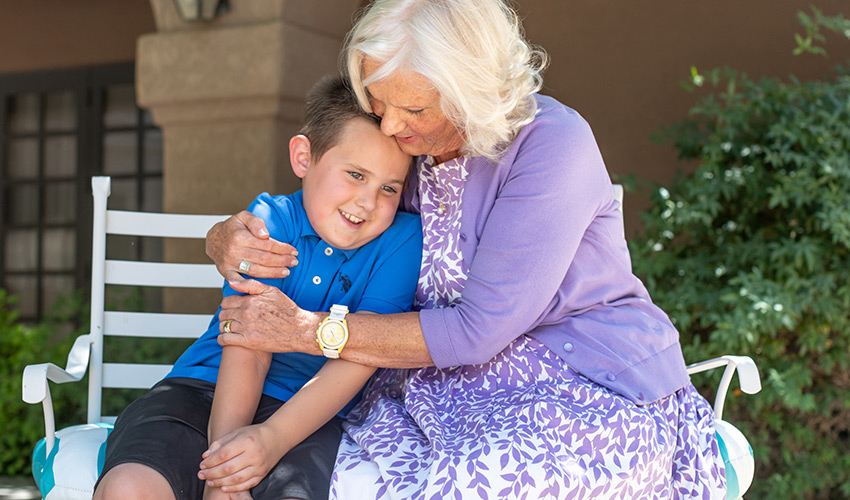 A grandparent hugging a grandchild.