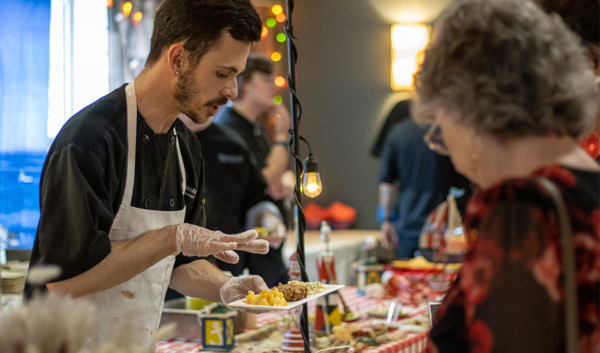 People being served in a buffet line.