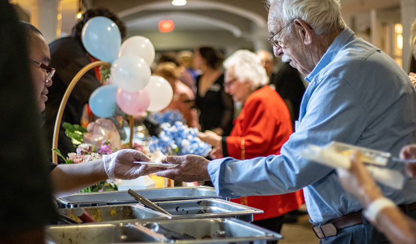 People in a buffet line.