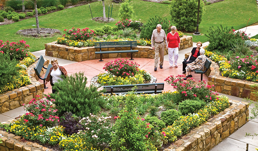 A bunch of residents enjoying the courtyard garden.