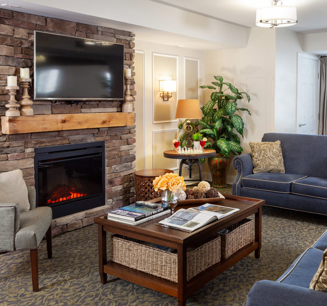 Seating area by fireplace at Pinebrook.