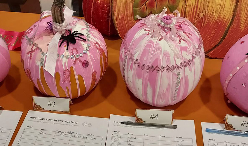 Painted pumpkins on a table.