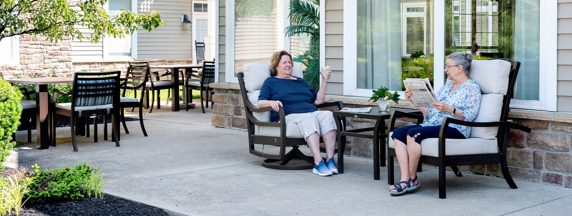 Two people sitting on the patio.