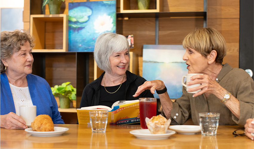 People at a table discussing books.