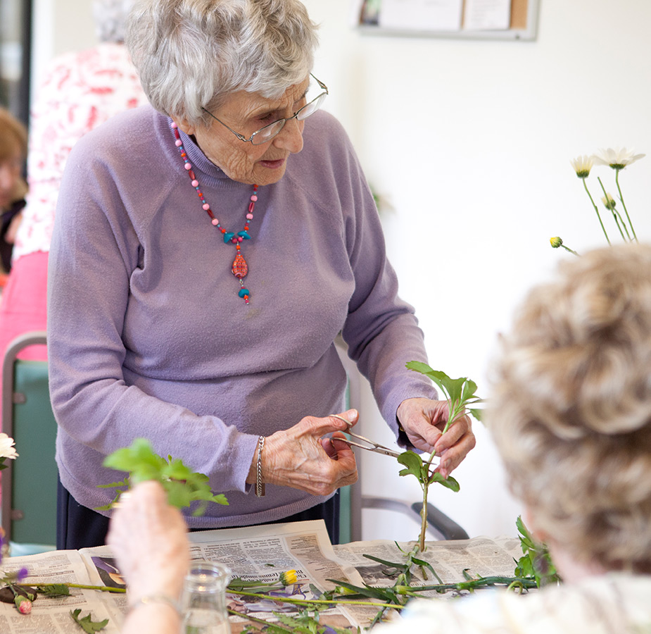 People in a floral arrangement class.