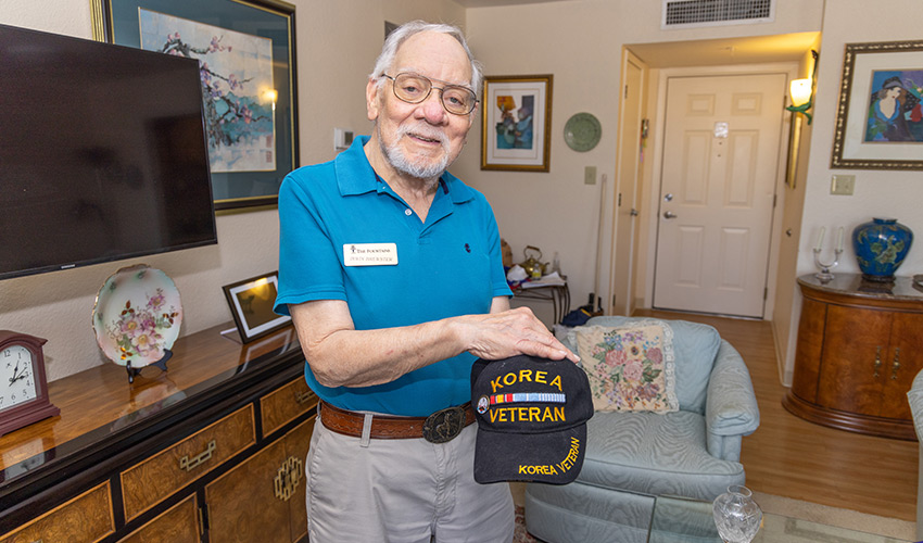 A veteran showing a hat.