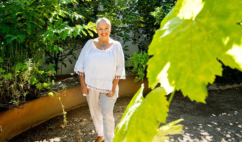 A woman in a green space outdoors.