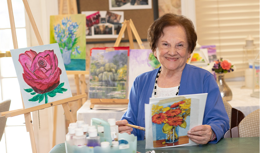 A person holding a painting.