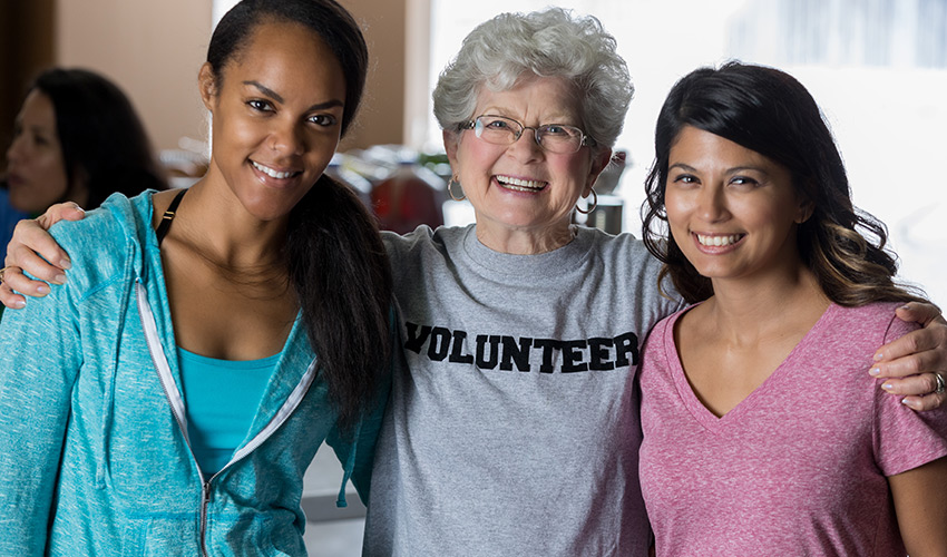 three smiling volunteers