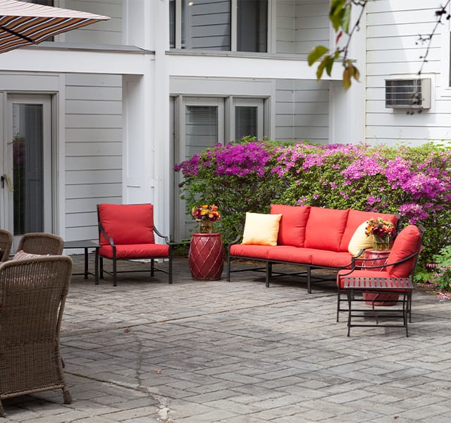 Red patio chairs in courtyard.