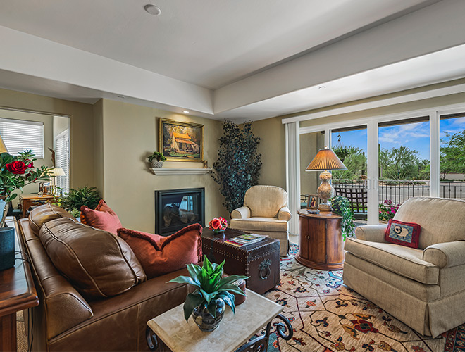 Furnished living room space with sofa, table, and seating area.