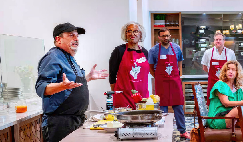 A person teaching in a kitchen.