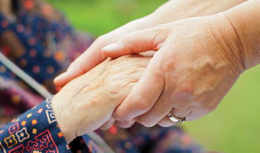 close shot of two people holding hands