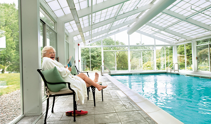 A person sitting by the pool.