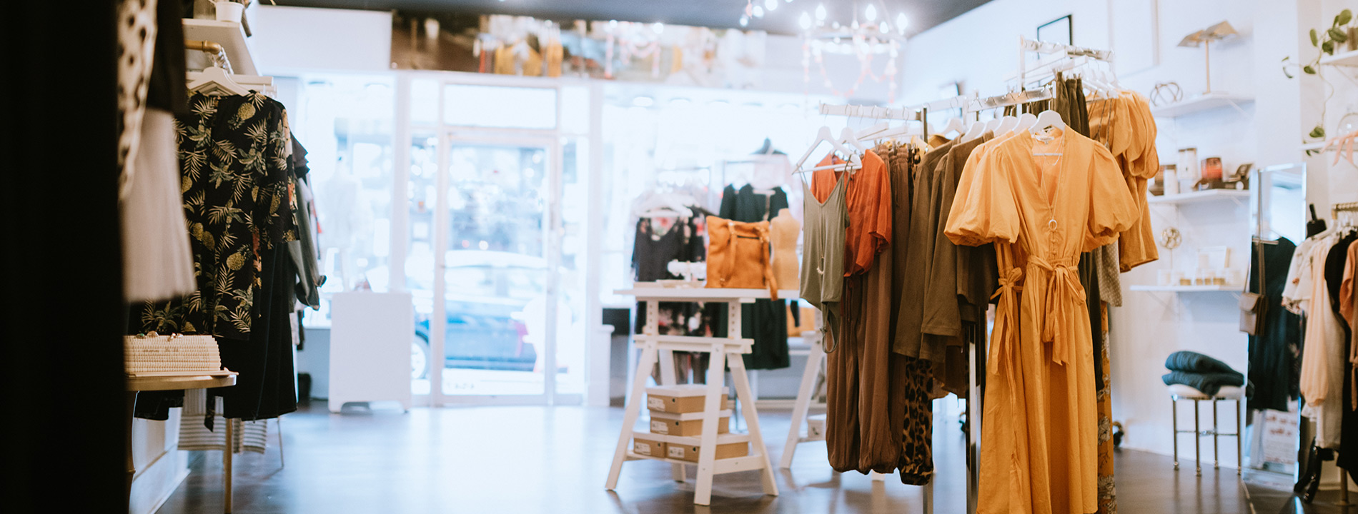 A shop with dresses on the wrack.