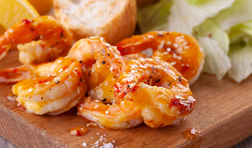 Cooked glazed jumbo shrimp.