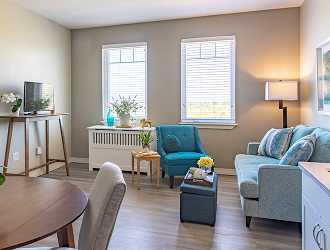 living area with a sofa, chair, table and tv