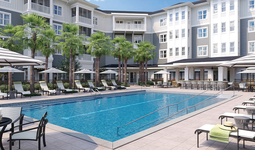 A pool with lounge chair all around it.