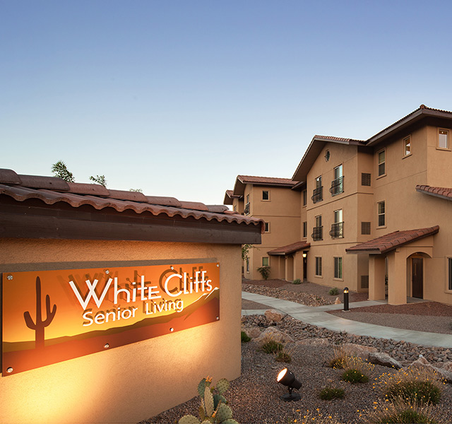 The entrance to White Cliffs Senior Living at sunset.