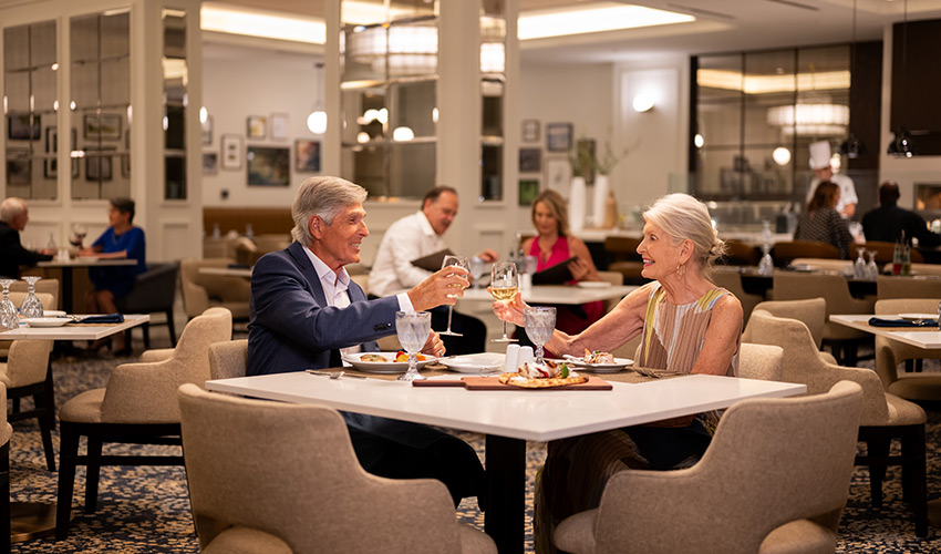 People out to dinner and toasting with drinks.