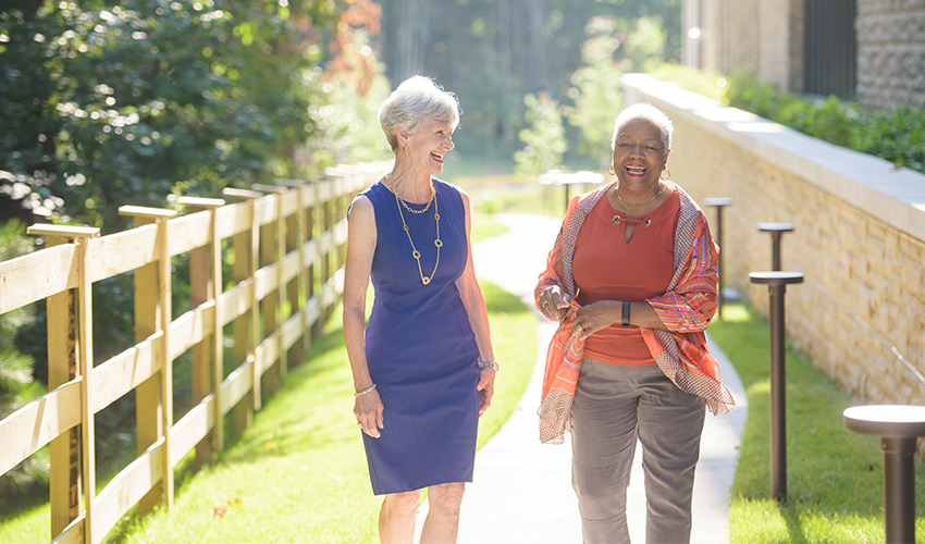 Two people walking and laughing together.