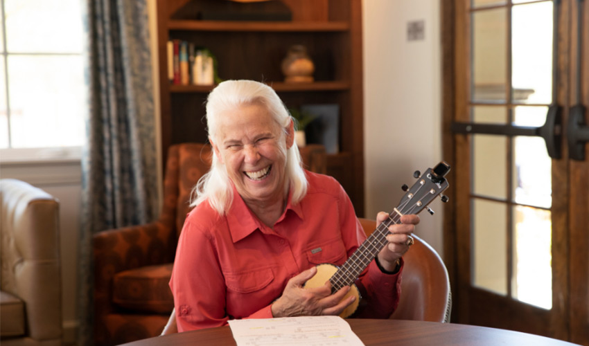 A person playing the ukulele. 