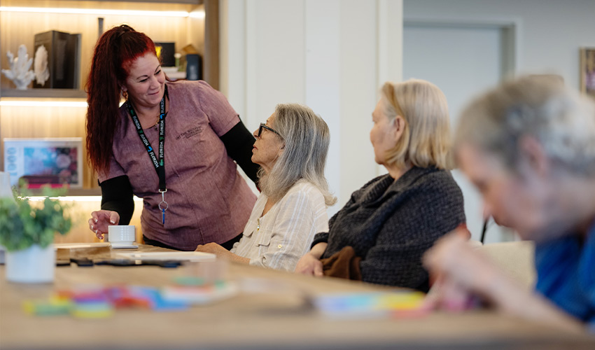 An associate working with people at a table.