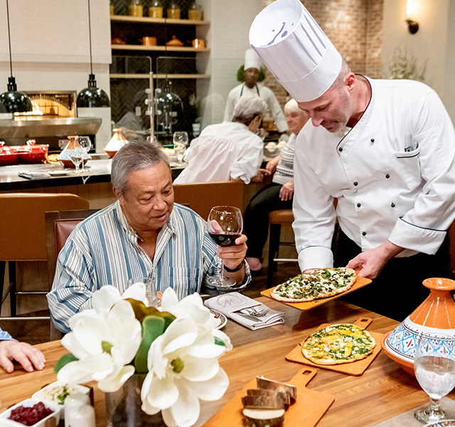 People being served by the chef.