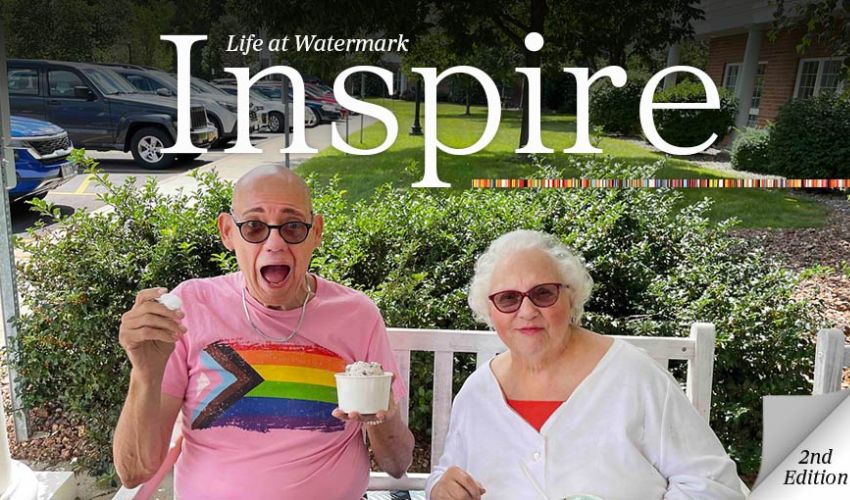 Two residents smiling and eating ice cream.